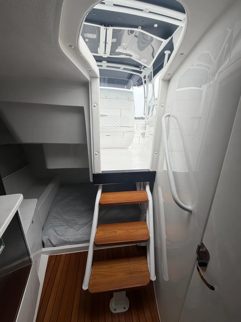 Slide: The Image of Interior of 2024 Intrepid Valor with wooden stairs and sleeping area. - 17