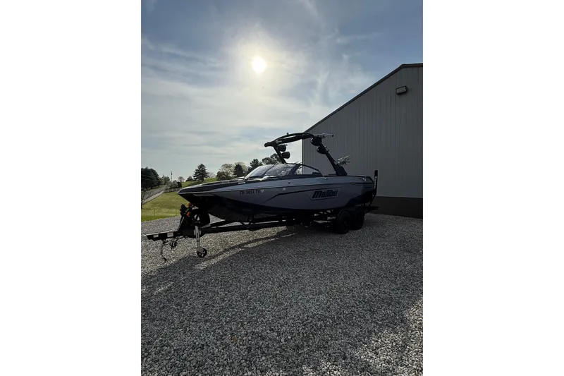 Slide: The Image of 2023 Malibu Wakesetter 23 LSV boat parked outdoors under a bright sky. - 3