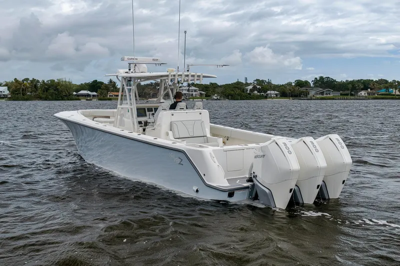 Slide: The Image of 2022 SeaVee 370Z boat with triple Mercury engines on a calm waterway. - 13