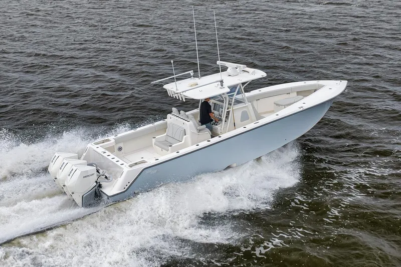 Slide: The Image of 2022 SeaVee 370Z boat cruising on open water with triple Mercury engines. - 16