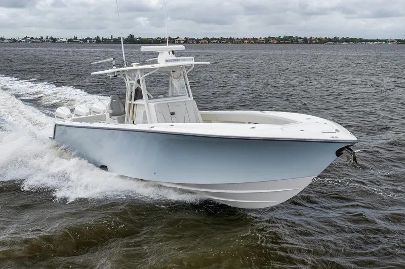 Slide: The Image of 2022 SeaVee 370Z boat cruising on open water under cloudy skies. - 21