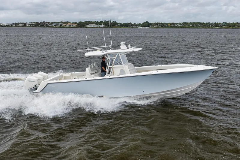 Slide: The Image of 2022 SeaVee 370Z boat cruising on open water, showcasing sleek design and powerful engines. - 22