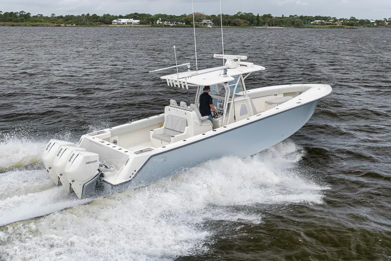 Slide: The Image of 2022 SeaVee 370Z boat cruising on open water with twin Mercury engines. - 23