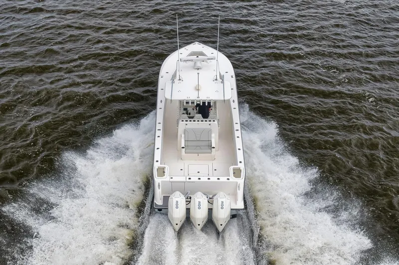 Slide: The Image of 2022 SeaVee 370Z boat cruising on open water, rear view with triple engines. - 24