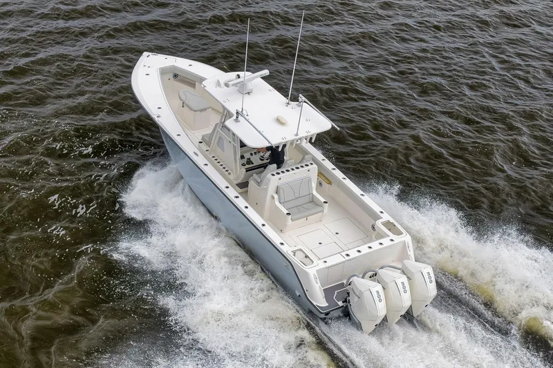 Slide: The Image of 2022 SeaVee 370Z boat cruising on water with triple outboard engines. - 25