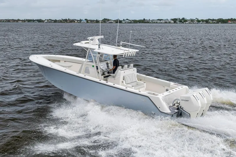 Slide: The Image of 2022 SeaVee 370Z boat cruising on open water with triple Mercury engines. - 27