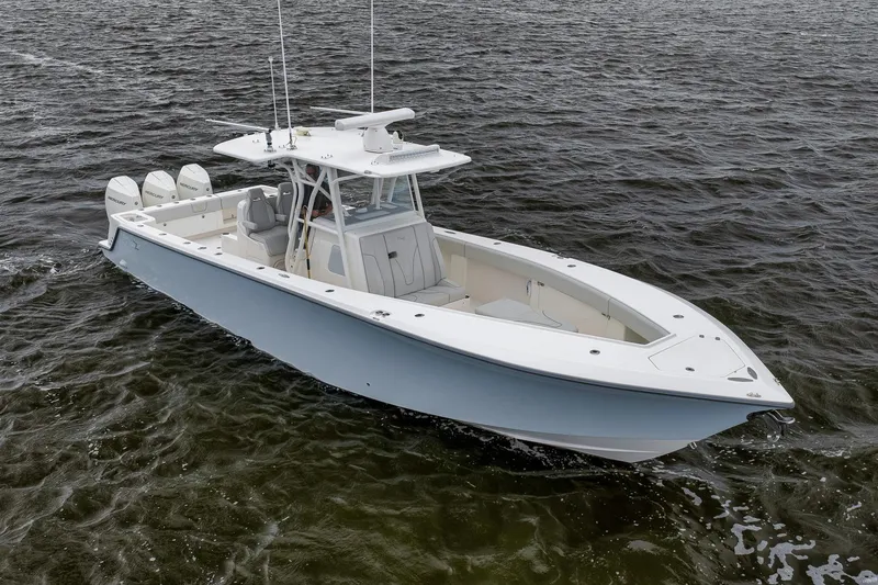 Slide: The Image of 2022 SeaVee 370Z boat cruising on open water, featuring triple outboard engines. - 3