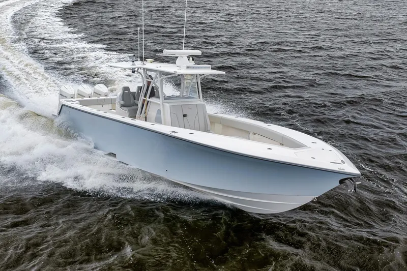 Slide: The Image of 2022 SeaVee 370Z boat cruising on open water, showcasing sleek design and powerful engines. - 32