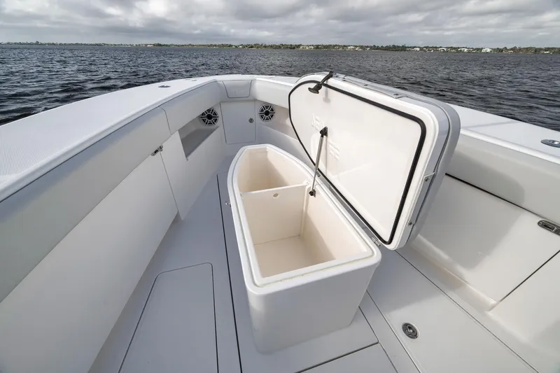 Slide: The Image of 2022 SeaVee 370Z boat with open storage compartment on deck, near water. - 34