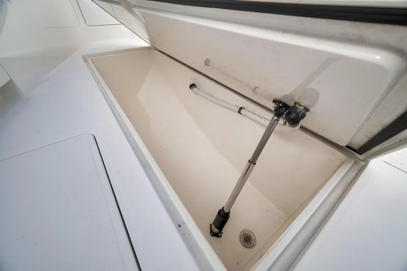 Slide: The Image of Open storage compartment on 2022 SeaVee 370Z boat, showcasing interior space and hydraulic support. - 38