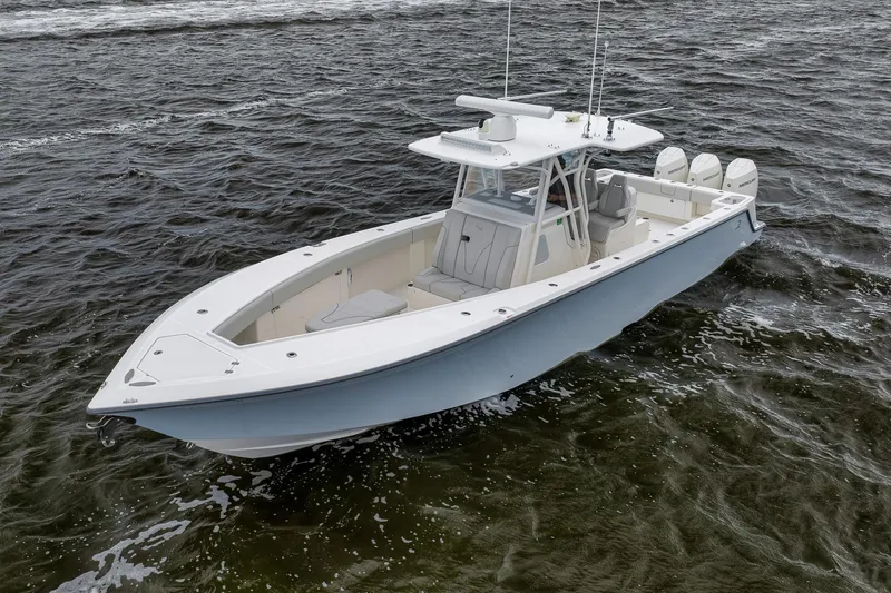 Slide: The Image of 2022 SeaVee 370Z boat on open water, featuring triple outboard engines. - 4