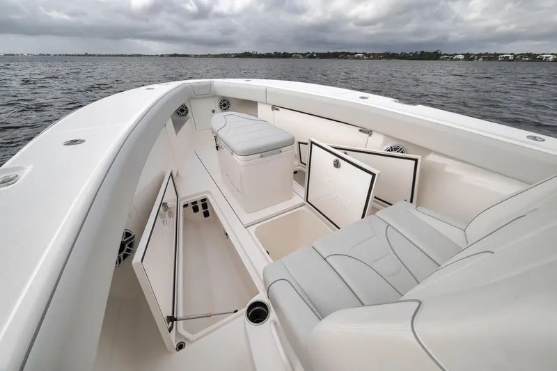Slide: The Image of 2022 SeaVee 370Z boat interior with open storage compartments on a cloudy day. - 42