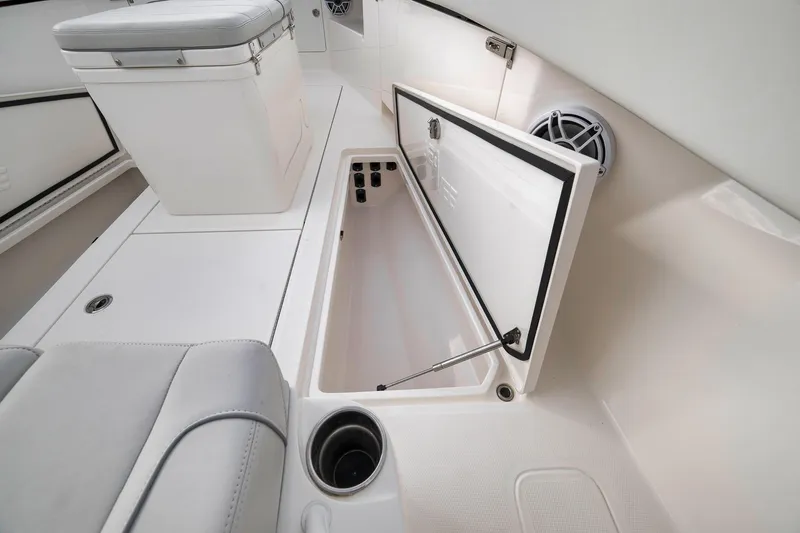 Slide: The Image of 2022 SeaVee 370Z boat interior with open storage compartment and seating. - 45