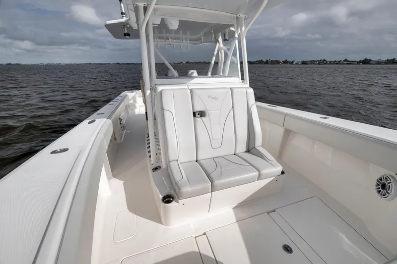 Slide: The Image of 2022 SeaVee 370Z boat interior with cushioned seating, on open water. - 46