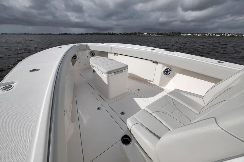 Slide: The Image of 2022 SeaVee 370Z boat interior with seating, under cloudy sky on water. - 47