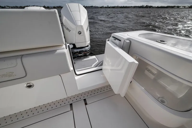 Slide: The Image of 2022 SeaVee 370Z boat with open storage compartment and Mercury outboard engine. - 49