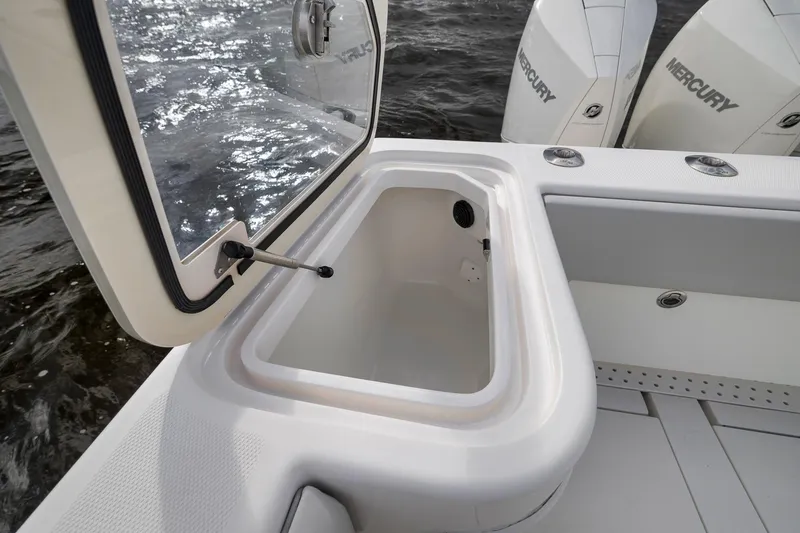 Slide: The Image of Open storage compartment on 2022 SeaVee 370Z boat with Mercury engines in background. - 52