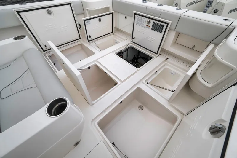 Slide: The Image of 2022 SeaVee 370Z boat interior with open storage compartments and seating. - 56