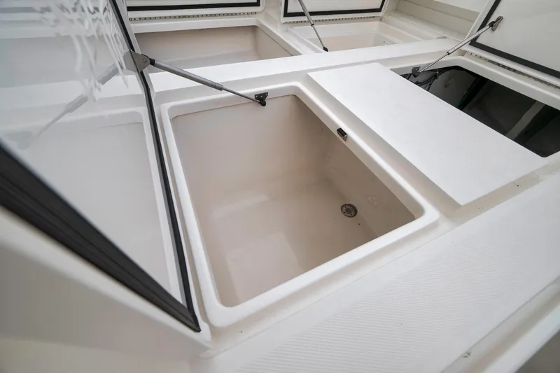 Slide: The Image of Open storage compartments on a 2022 SeaVee 370Z boat deck. - 58