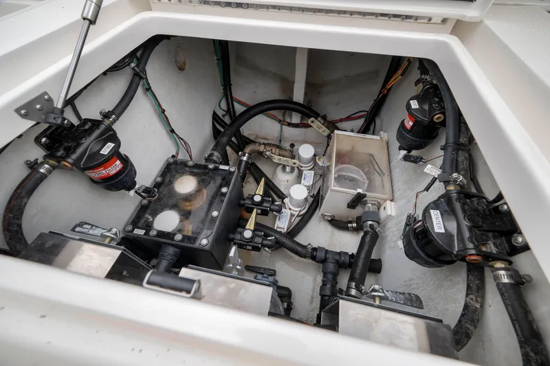 Slide: The Image of Engine compartment of a 2022 SeaVee 370Z boat, showcasing mechanical components and wiring. - 59