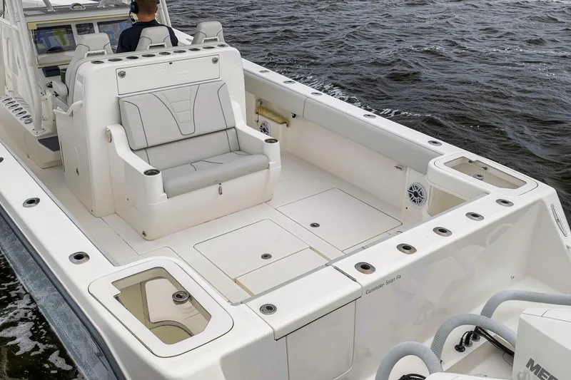 Slide: The Image of 2022 SeaVee 370Z boat interior with seating and storage, on water. - 6