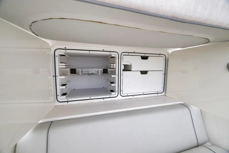Slide: The Image of 2022 SeaVee 370Z boat storage compartments with sleek white interior design. - 61