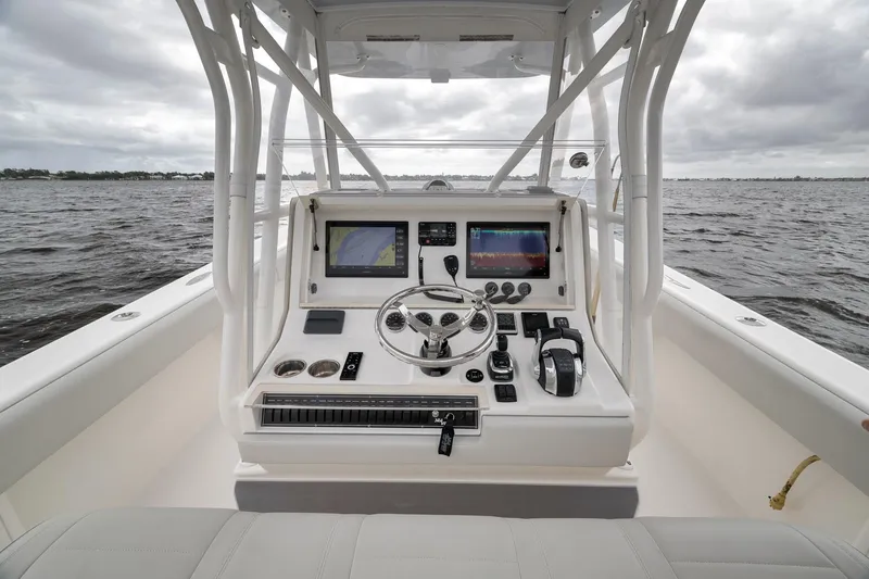 Slide: The Image of 2022 SeaVee 370Z boat helm with advanced navigation and control systems on open water. - 62