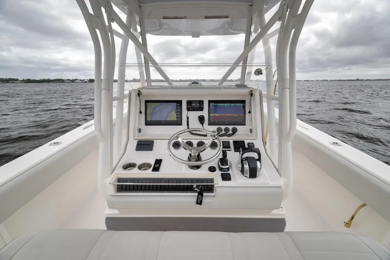 Slide: The Image of 2022 SeaVee 370Z boat helm with advanced navigation and control systems on open water. - 63