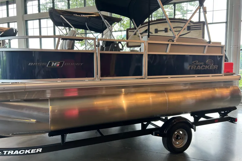 The Image of 2026 Sun Tracker Bass Buggy 16 XL Select pontoon boat on display indoors. - 0