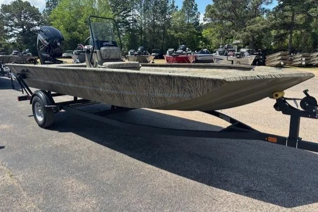 Slide: The Image of 2026 Tracker Grizzly 1860 CC boat on trailer, parked outdoors. - 5