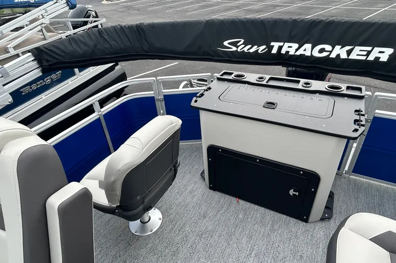 Slide: The Image of 2026 Sun Tracker Fishin' Barge 20 DLX interior with seating and fishing station. - 15