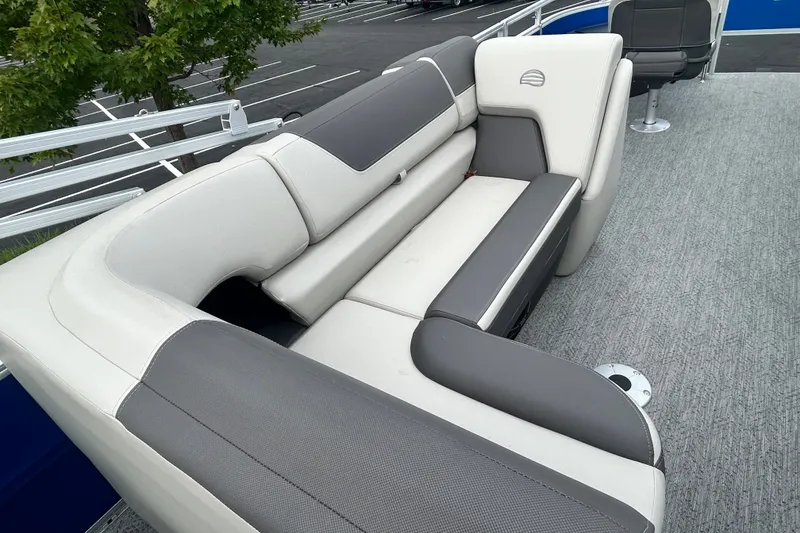 Slide: The Image of 2026 Sun Tracker Fishin' Barge 20 DLX interior seating with gray and white upholstery. - 17