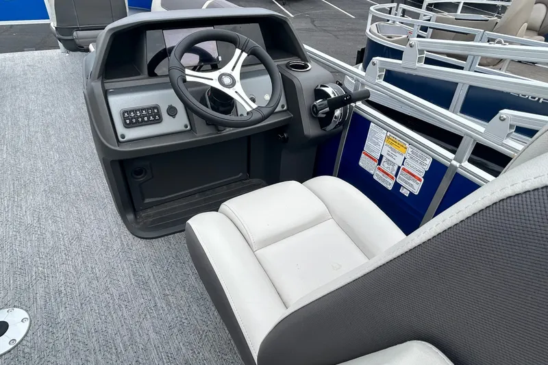 Slide: The Image of 2026 Sun Tracker Fishin' Barge 20 DLX helm with steering wheel and control panel. - 16