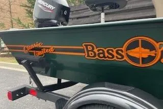 Slide: The Image of 2026 Tracker Bass Tracker Classic Limited boat with Mercury engine, parked on a trailer. - 43