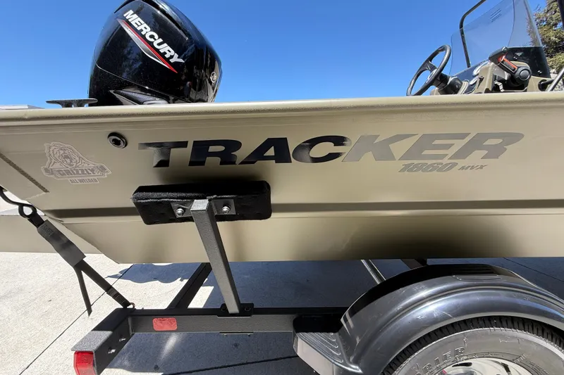 Slide: The Image of 2026 Tracker Grizzly 1860 CC boat with Mercury engine on trailer, side view. - 10