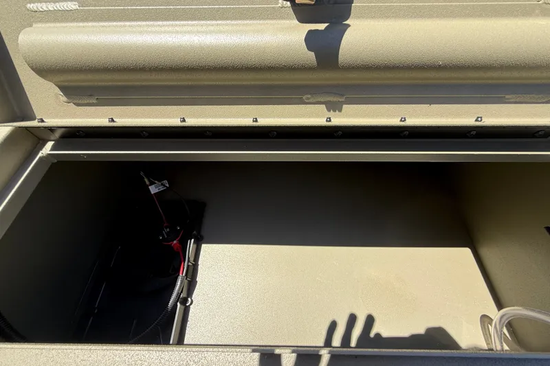 Slide: The Image of Storage compartment of 2026 Tracker Grizzly 1860 CC boat, featuring interior wiring. - 14