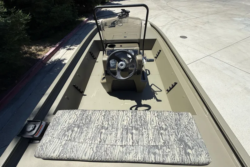 Slide: The Image of 2026 Tracker Grizzly 1860 CC boat interior with steering console and patterned seating. - 7
