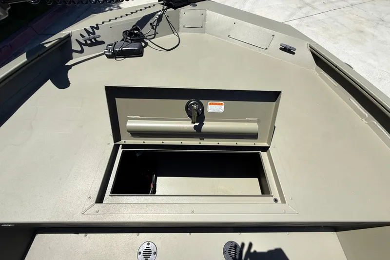 Slide: The Image of 2026 Tracker Grizzly 1860 CC boat deck with open storage compartment. - 15