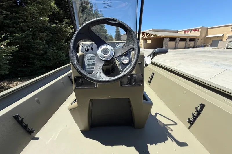 Slide: The Image of Steering console of 2026 Tracker Grizzly 1860 CC boat, parked outdoors. - 25