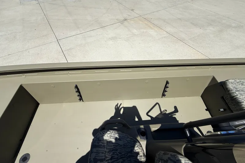Slide: The Image of 2026 Tracker Grizzly 1860 CC boat interior with camouflage seats and spacious deck. - 20