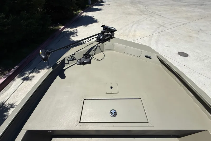 Slide: The Image of 2026 Tracker Grizzly 1860 CC boat deck with mounted trolling motor. - 16