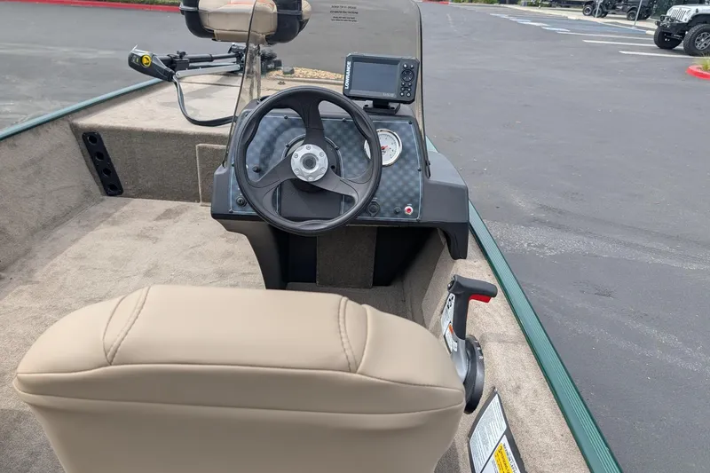 Slide: The Image of 2026 Tracker Bass Tracker Classic Limited boat interior with steering wheel and control panel. - 5