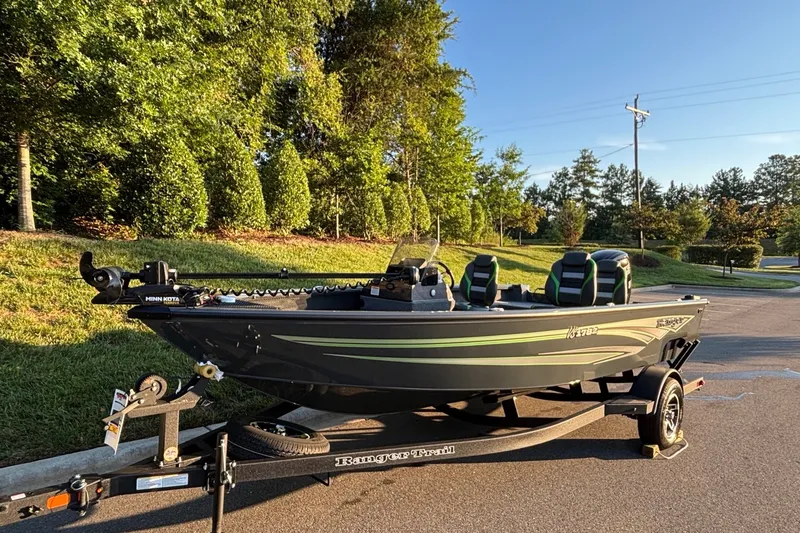 Slide: The Image of 2026 Ranger VS1782SC Angler boat on trailer, parked on a sunny road. - 2