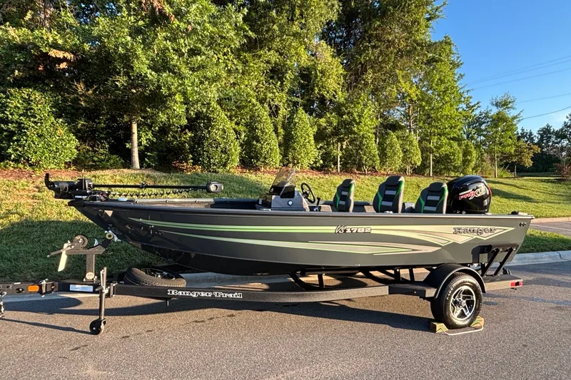 Slide: The Image of 2026 Ranger VS1782SC Angler boat on trailer, parked outdoors with lush greenery background. - 1