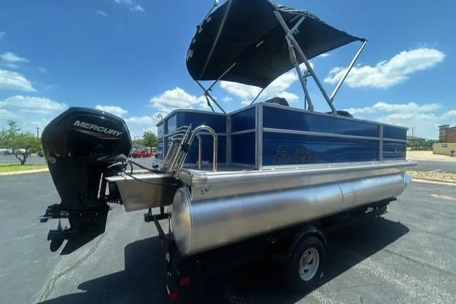 Slide: The Image of 2026 Sun Tracker Party Barge 18 DLX pontoon boat with Mercury engine, parked outdoors. - 3