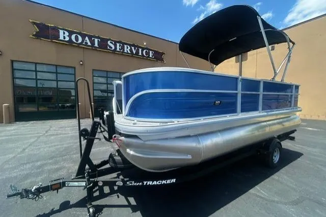 The Image of 2026 Sun Tracker Party Barge 18 DLX pontoon boat at a boat service center. - 0
