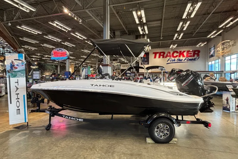 The Image of 2026 Tahoe T16 boat displayed indoors with Tracker signage in the background. - 0