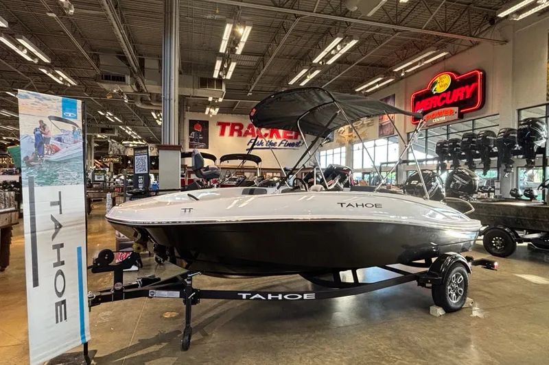 Slide: The Image of 2026 Tahoe T16 boat displayed in showroom with promotional banners and equipment. - 1