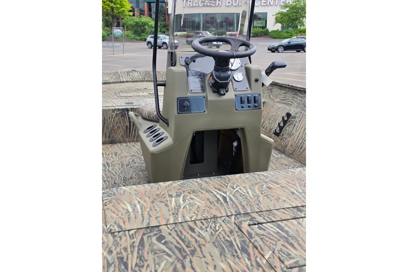 Slide: The Image of 2026 Tracker Grizzly 2072 CC boat with camouflage interior and central console. - 3