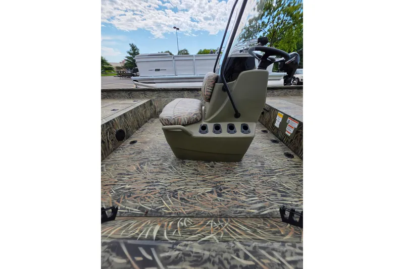 Slide: The Image of 2026 Tracker Grizzly 2072 CC boat interior with camouflage design and steering console. - 4